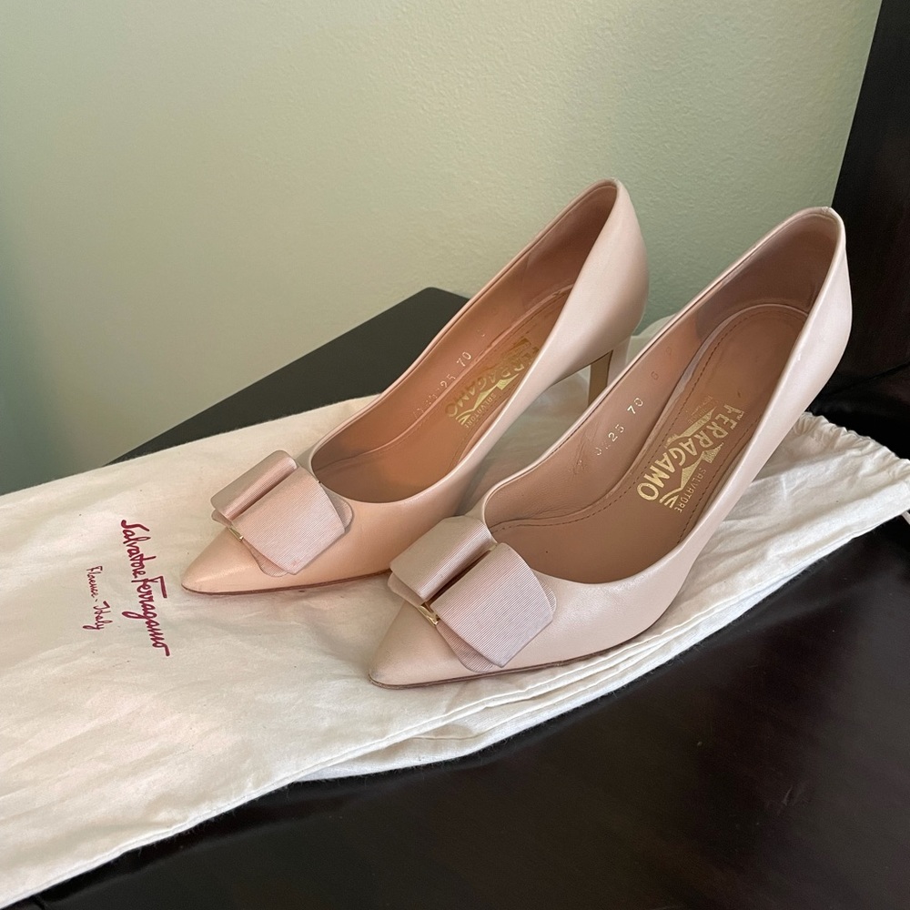 Nude Ferragamo Pumps with Bow and gold hardware.